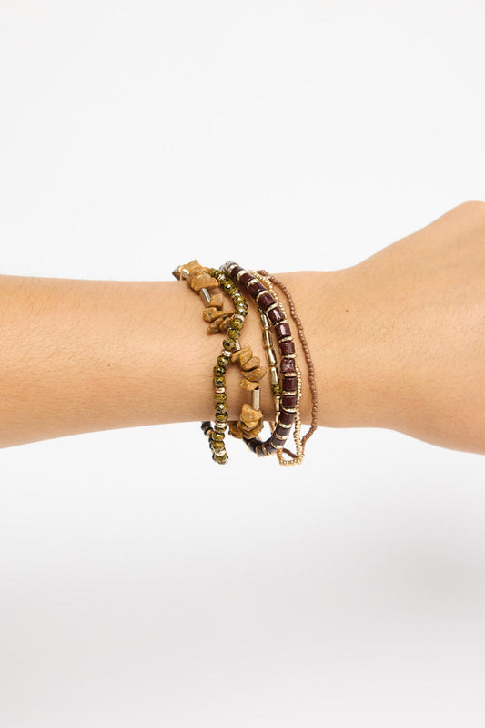 Solidarity Stack Bracelet in Natural worn stacked on the wrist, showing the multiple beaded strands layered together