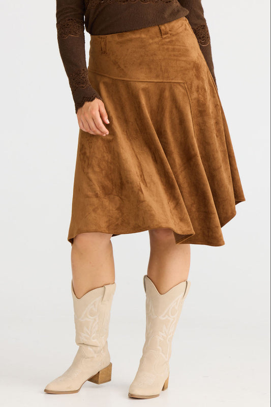 Model wearing Runa Skirt in chocolate with natural waist fit, side view on white background