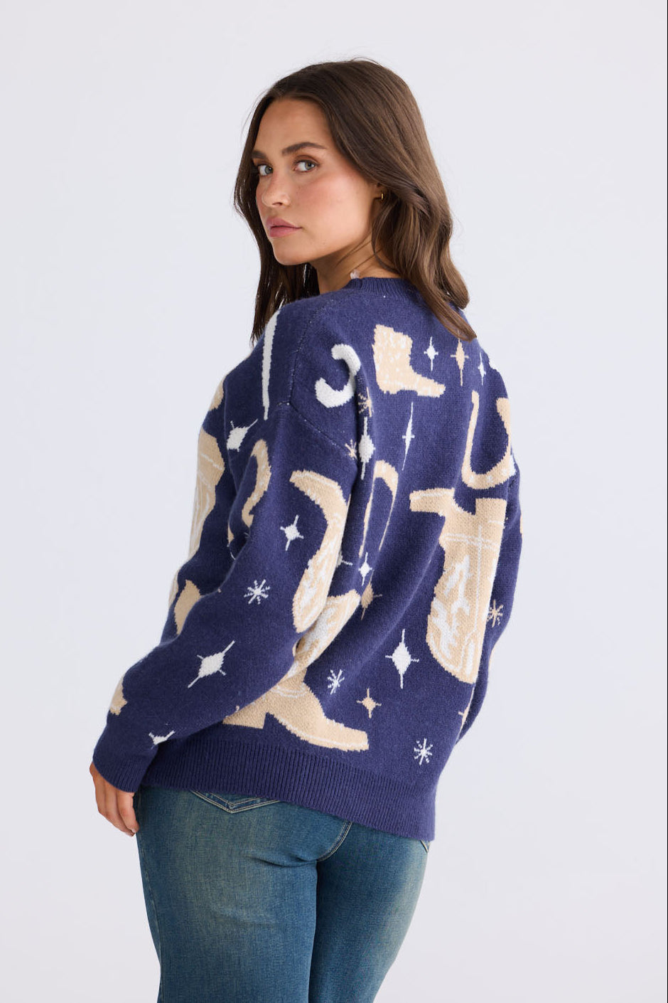 Model wearing Lucky Boots Knit in navy with ribbed neckline and cowboy-themed print, front view on white background