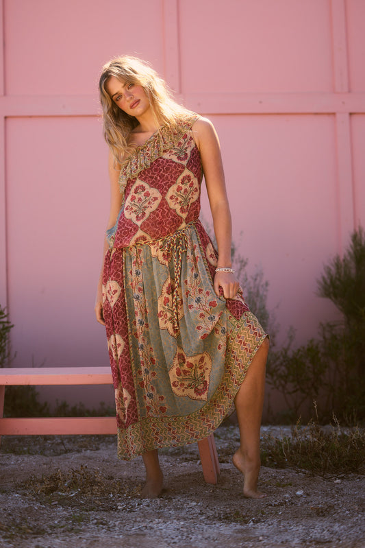 Ravina Dress in garden mist, full length against a pink wall.