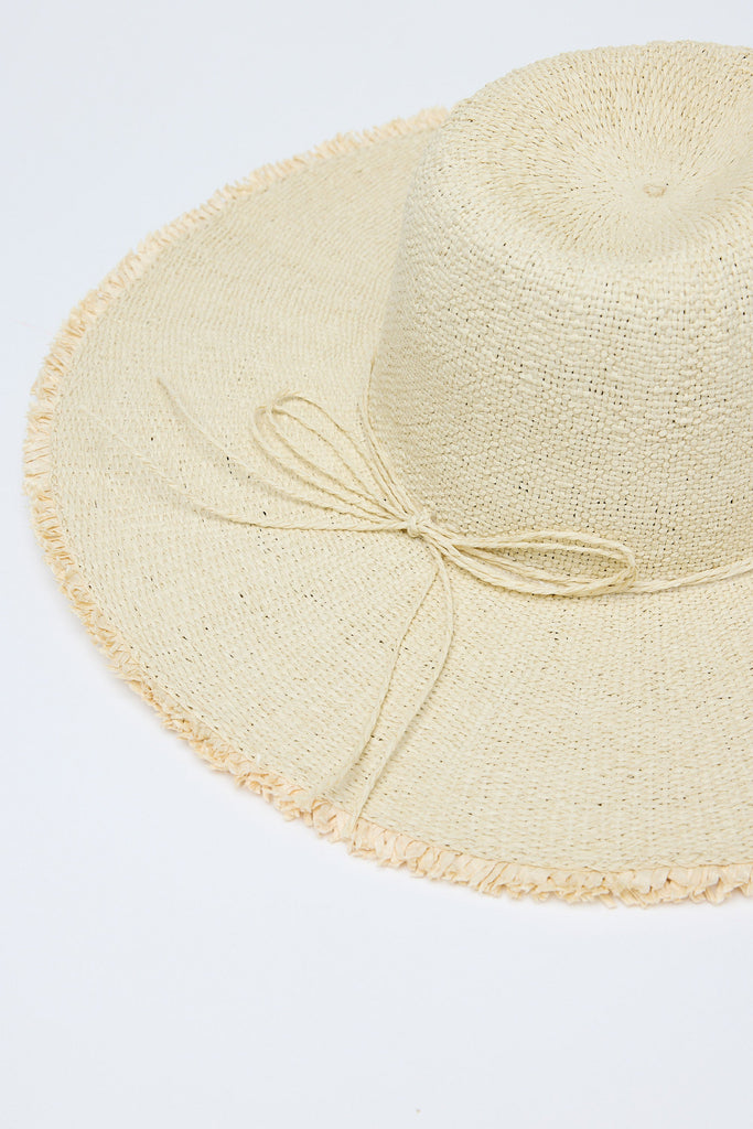 Beige straw hat with a ribbon on a light gray background