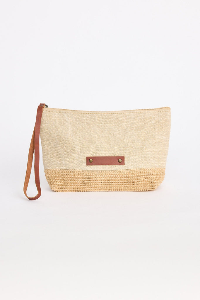 Woven clutch bag with leather strap on a white background
