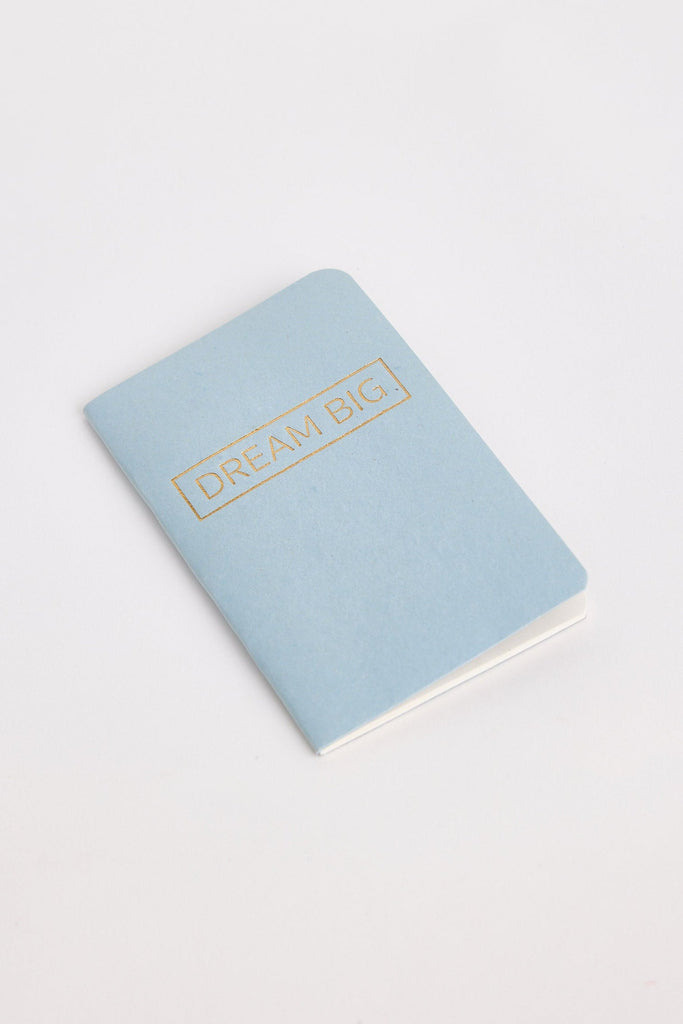 Light blue notebook with 'Dream Big' text on a white background
