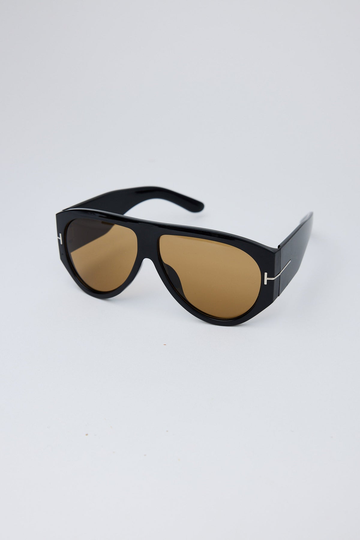 Detail view of Black Paparazzi Sunglasses on white background