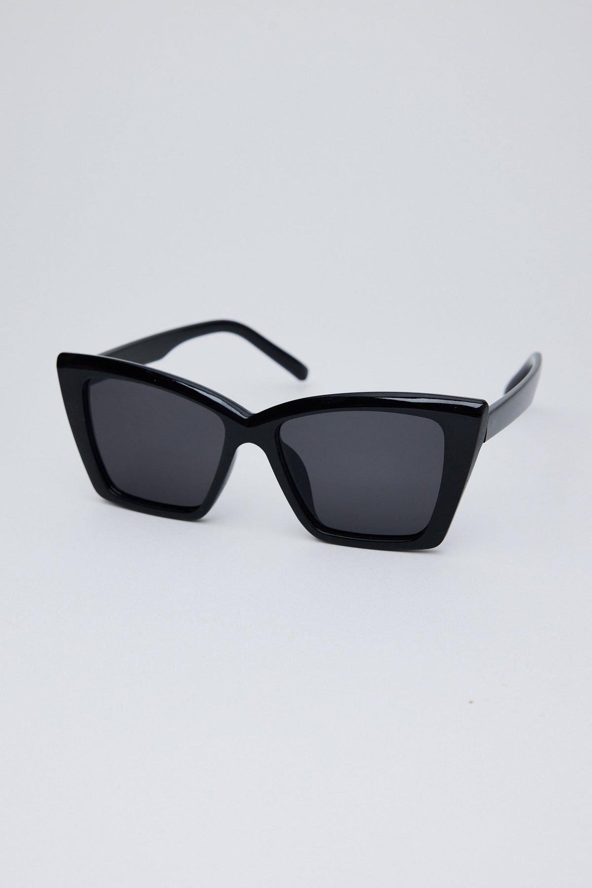 Angled view of Black Venice Sunglasses on white background