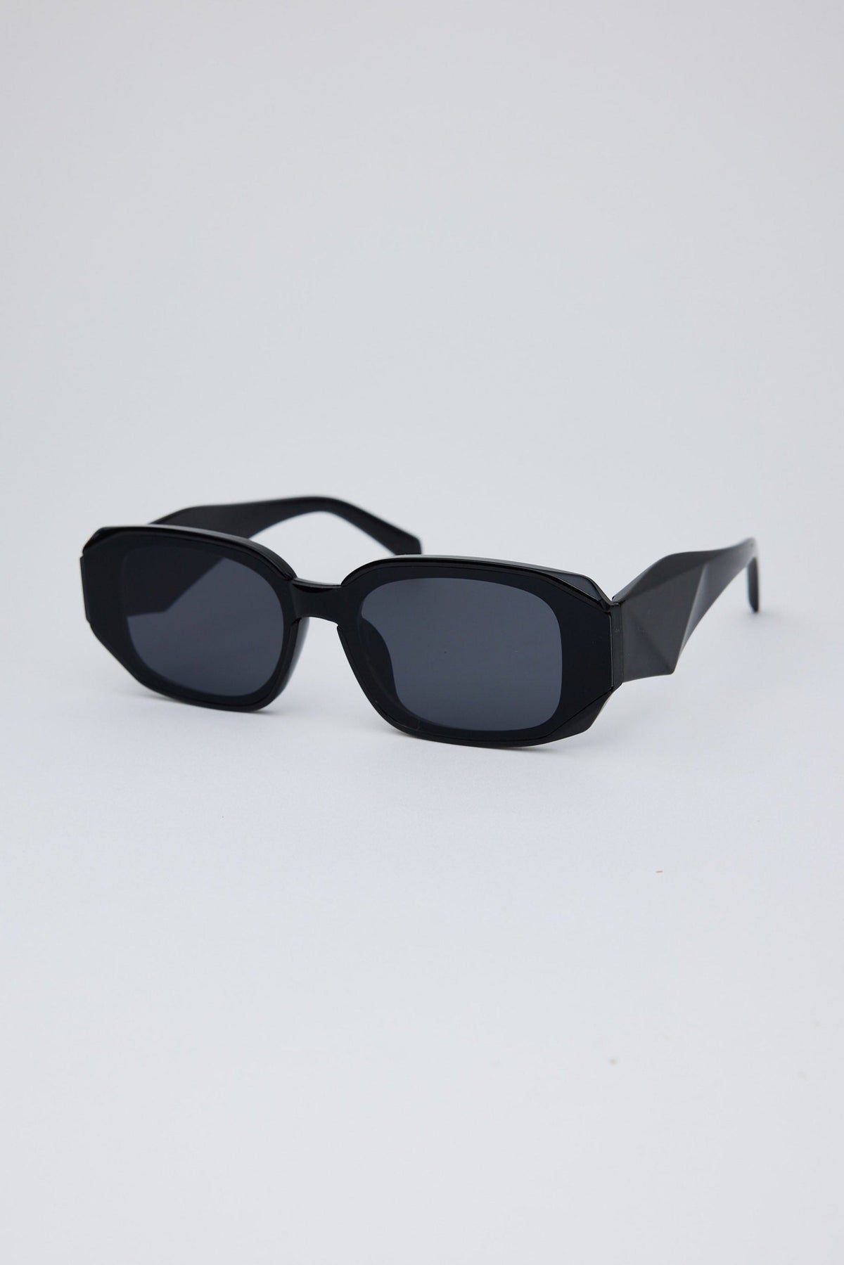 Angled view of Black London Sunglasses on white background
