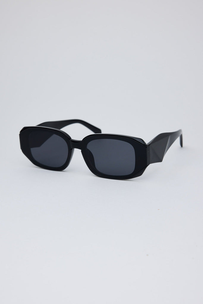 Black sunglasses on a light gray background