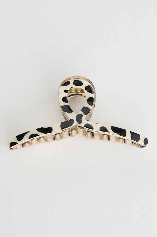 Hair clip with black and white pattern on a light gray background