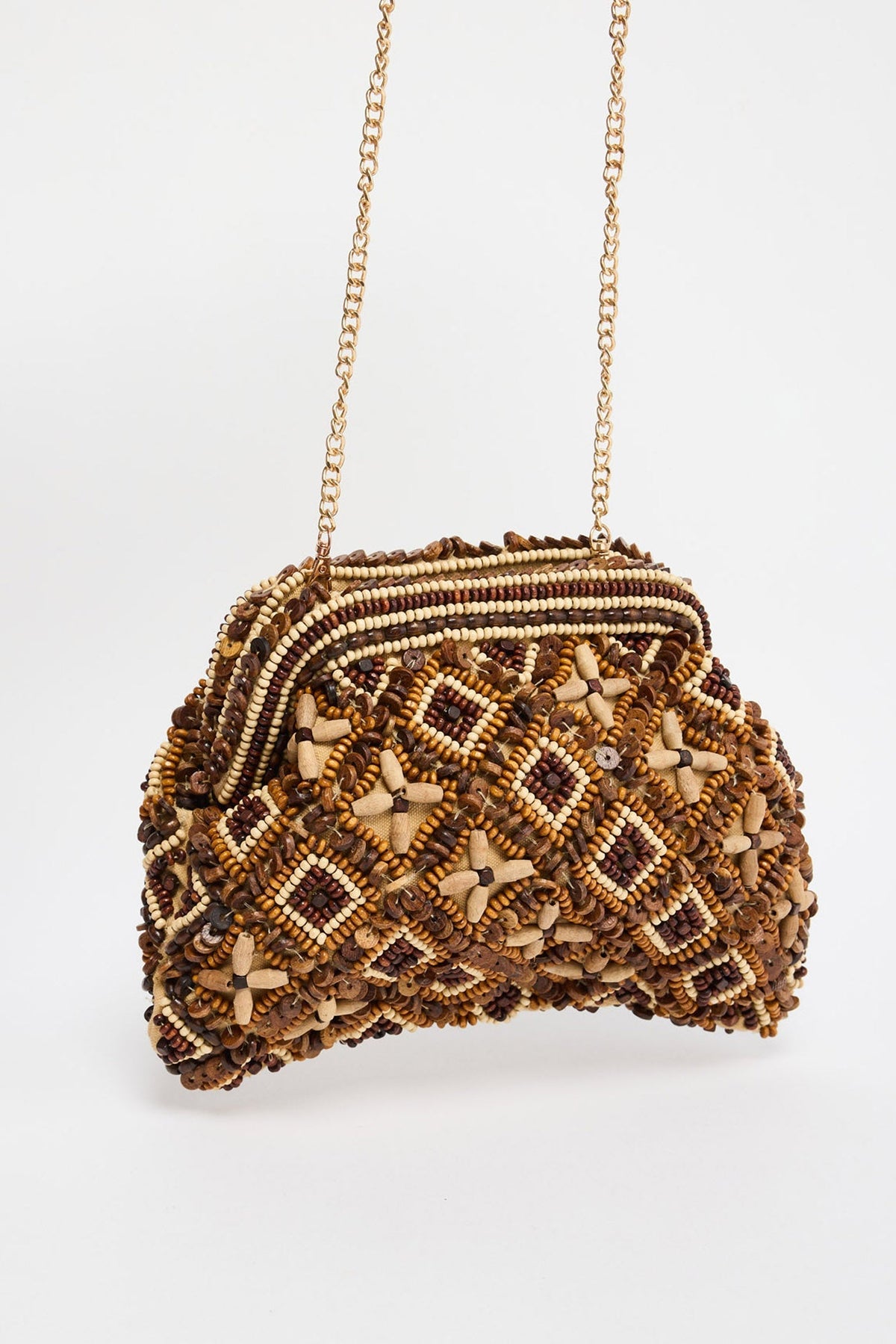 Half-moon shaped beaded clutch bag in chocolate brown and cream tones with a diamond lattice pattern and floral bead accents, hanging from a gold-tone chain strap against a white background