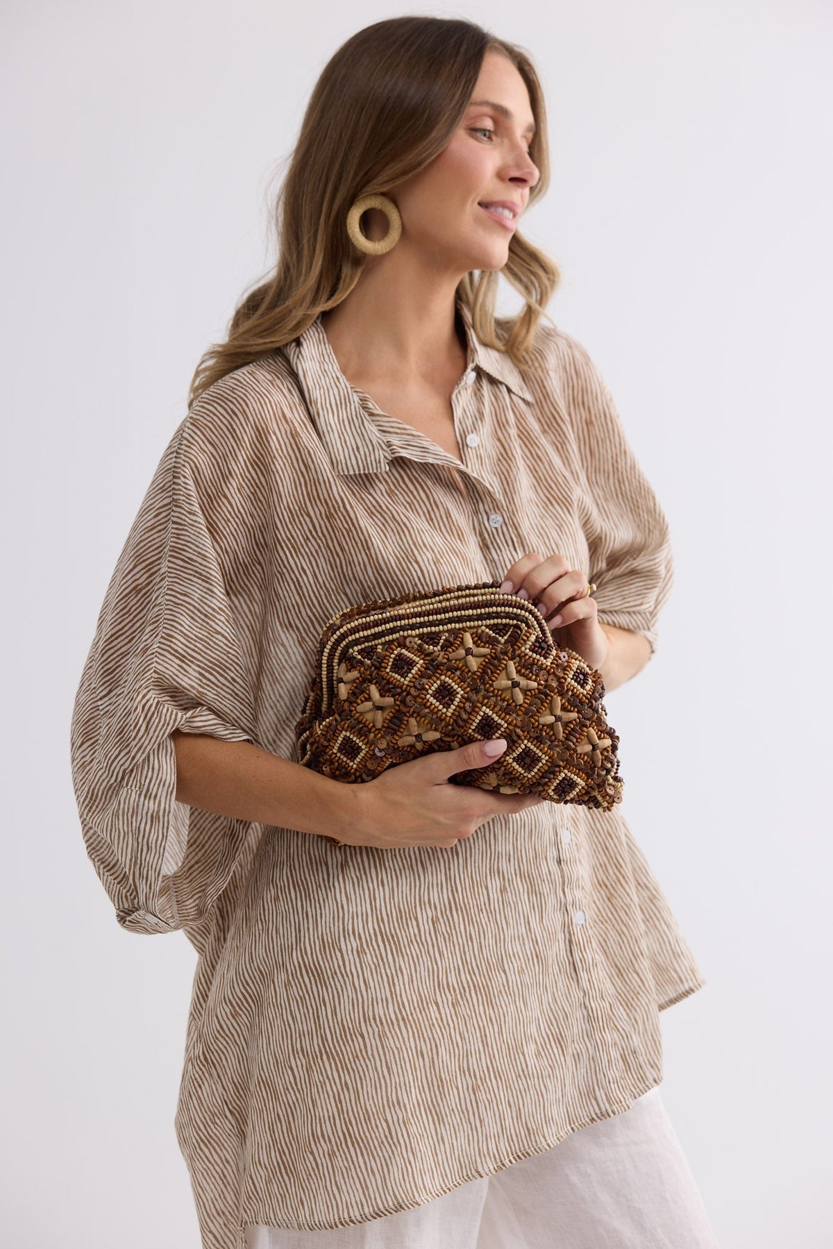 Isla Clutch in brown, side view.