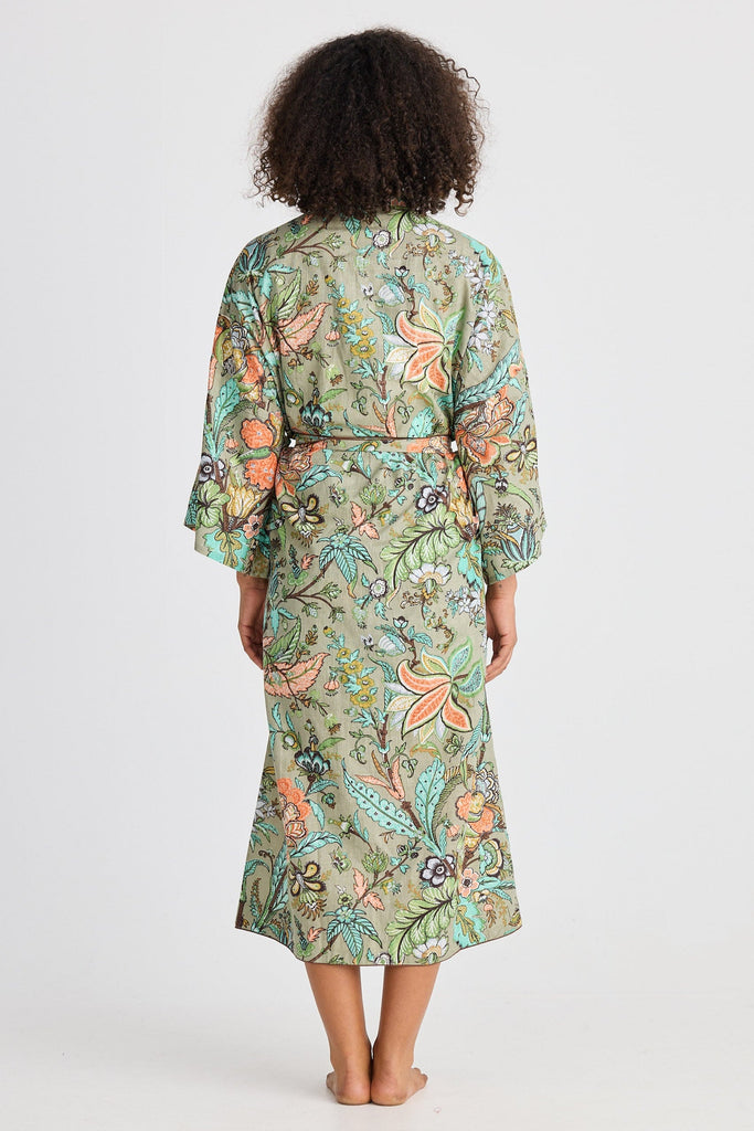 Woman wearing a floral patterned robe on a white background