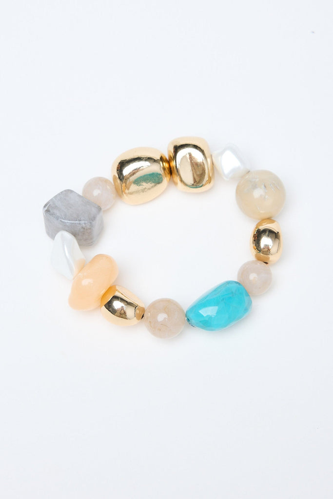 Multicolored beaded bracelet with gold clasp on a white background