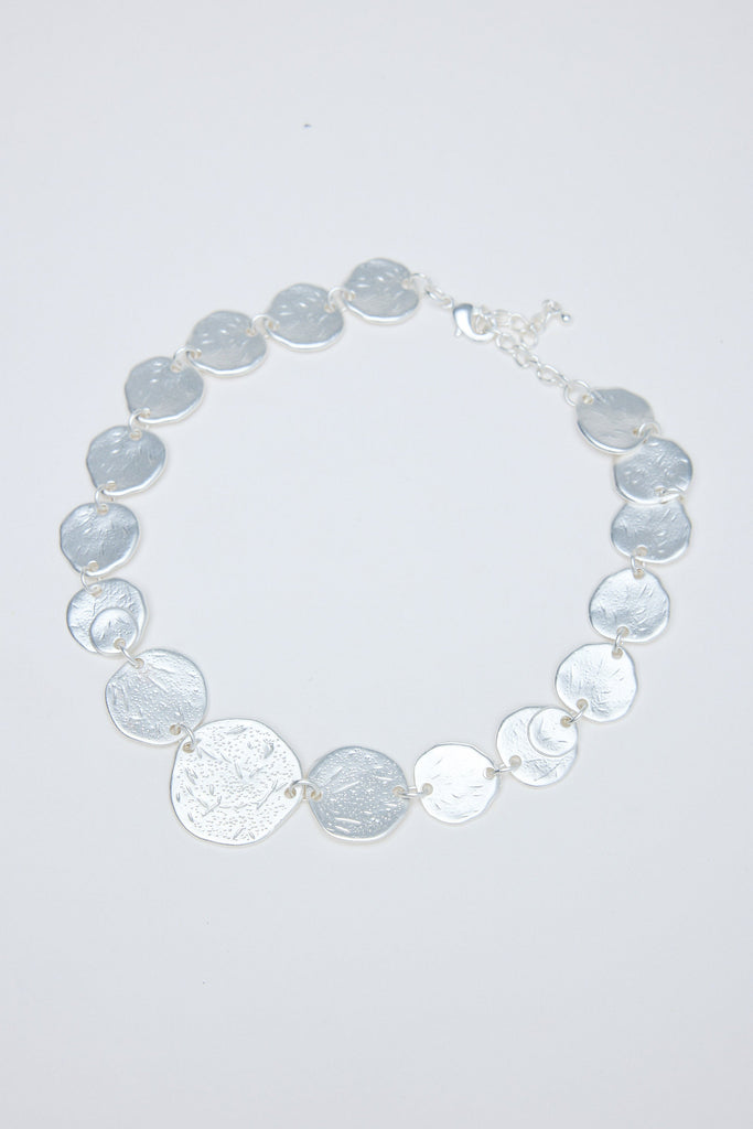 Necklace with gray and silver circular coins on a white background