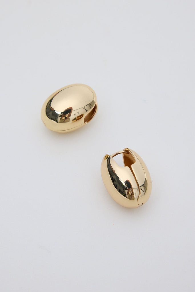 Gold hoop earrings on a light gray background