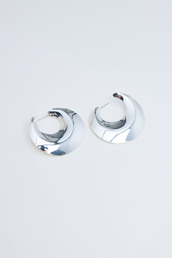 Pair of silver hoop earrings on a light gray background