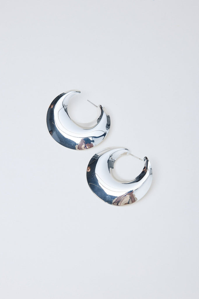 Pair of silver hoop earrings on a light gray background