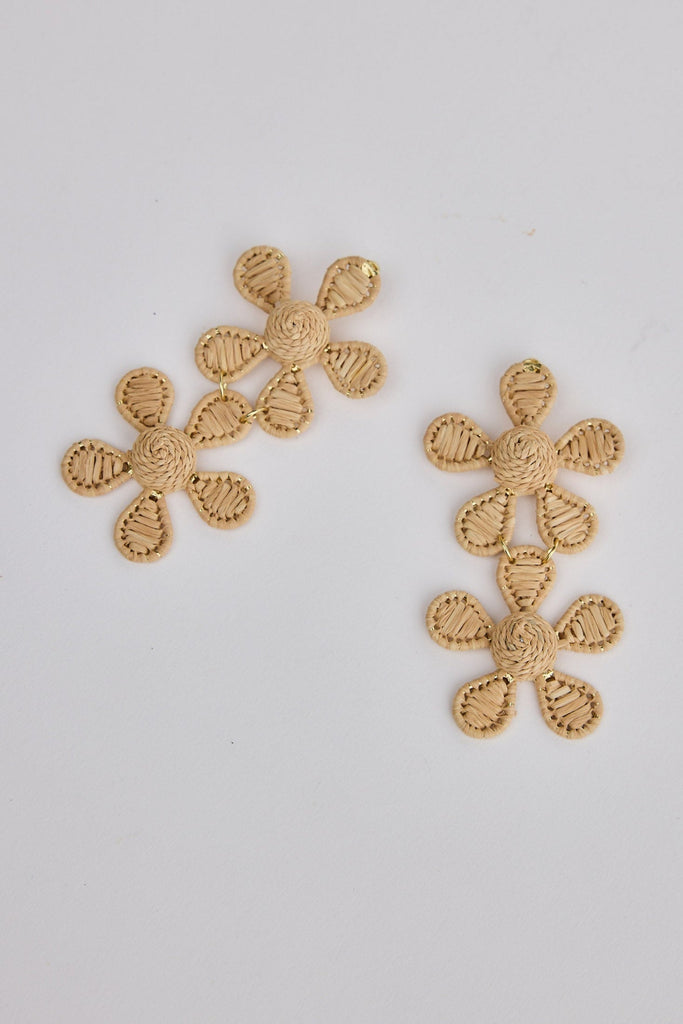 Pair of natural floral earrings on a light gray background