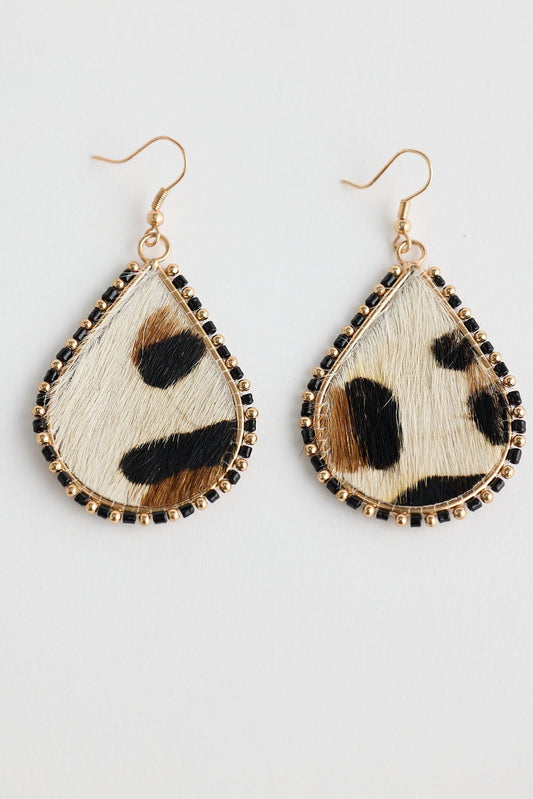 Teardrop-shaped earrings with animal print design on a light gray background