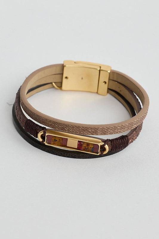 Multistrand bracelet with gold clasp on a light gray background