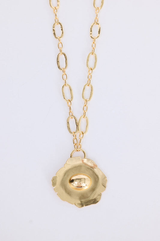 Flora Necklace in gold with sculptural floral pendant detail, front view on white background