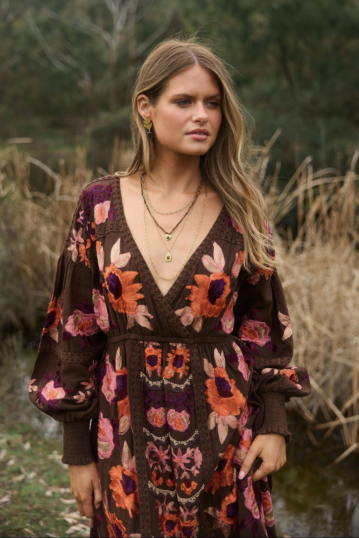 Woman wearing a patterned dress in a natural setting