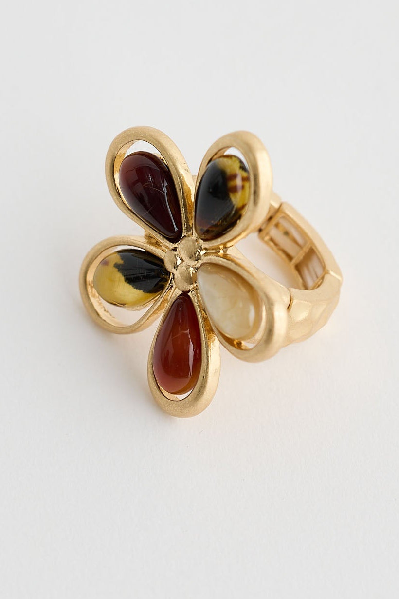 Gold ring with gemstones on a white background
