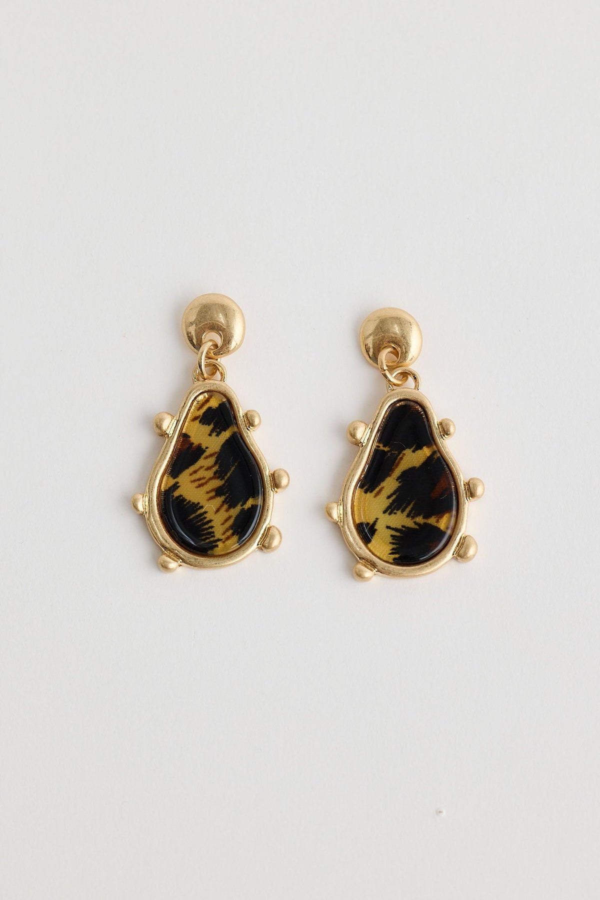 Pair of earrings with black and gold design on a white background