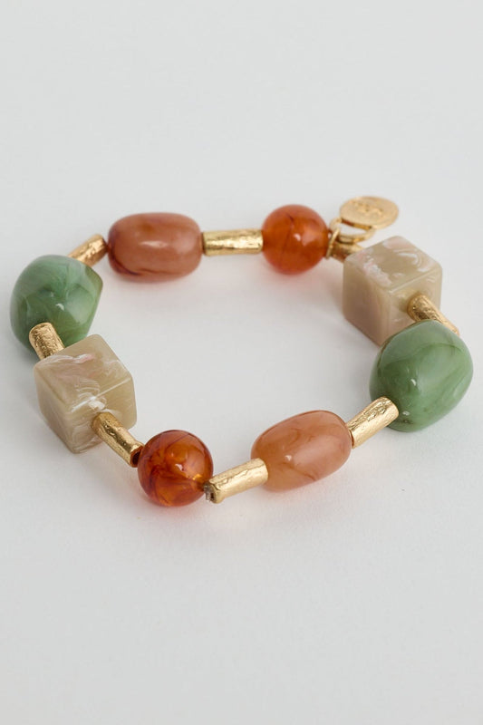 Beaded bracelet with multicolored beads on a light gray background