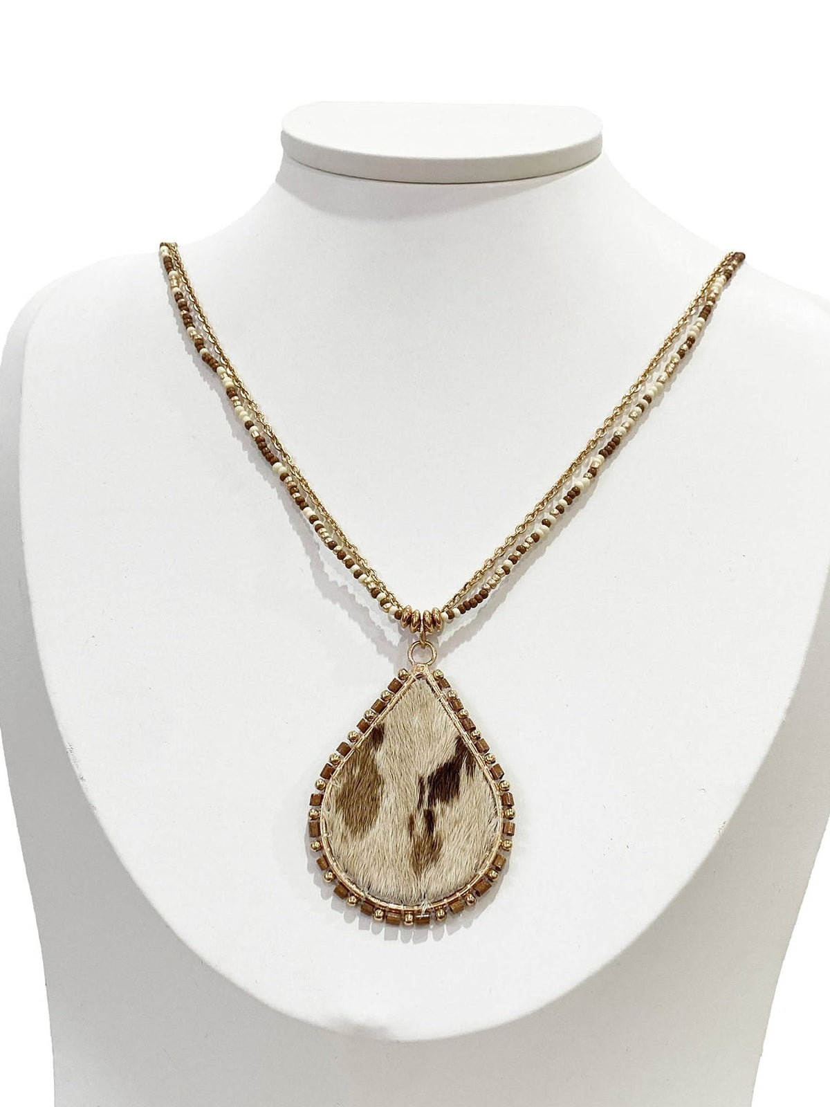 Necklace with a teardrop-shaped pendant on a white mannequin bust