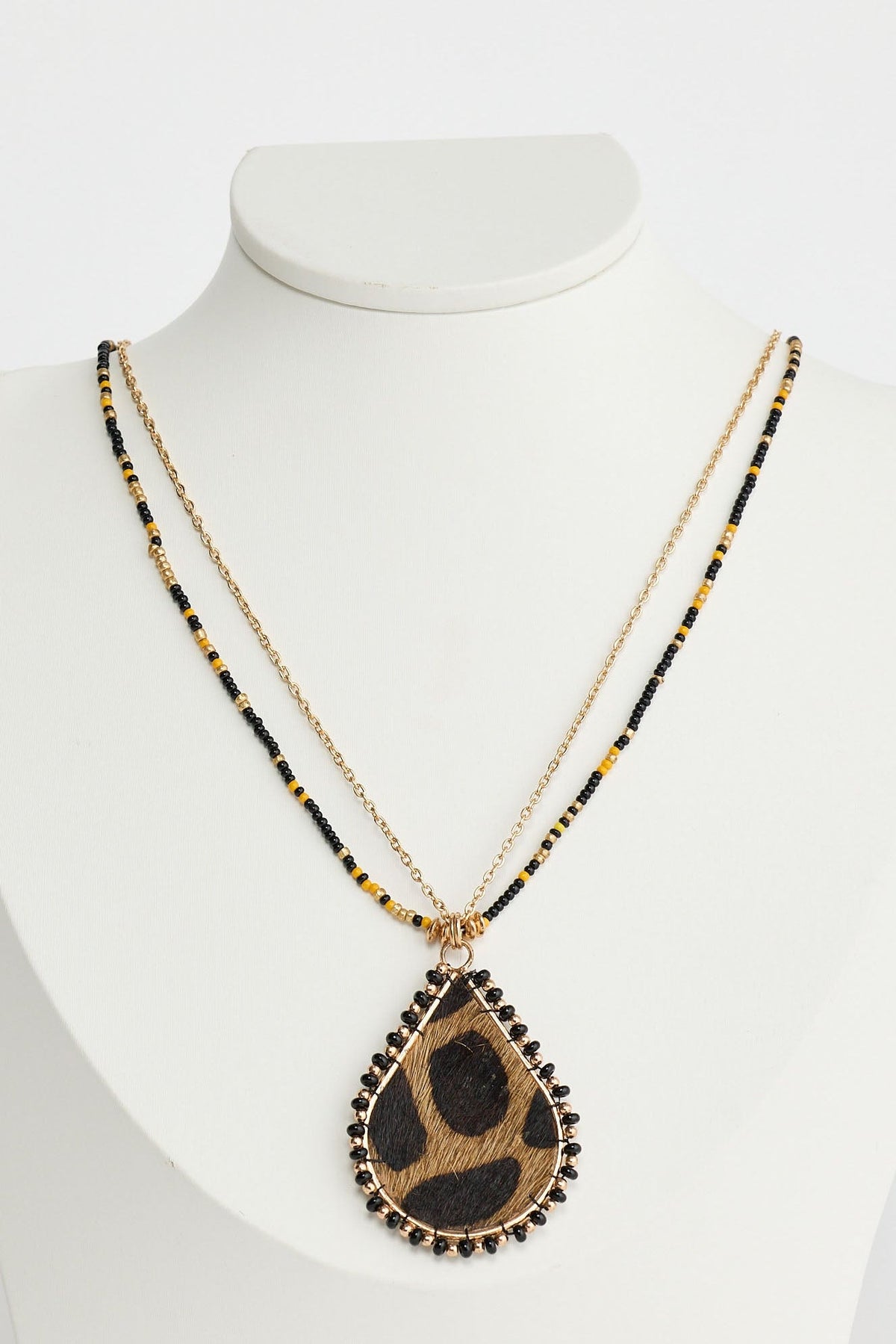 Necklace with a teardrop-shaped pendant on a mannequin against a white background