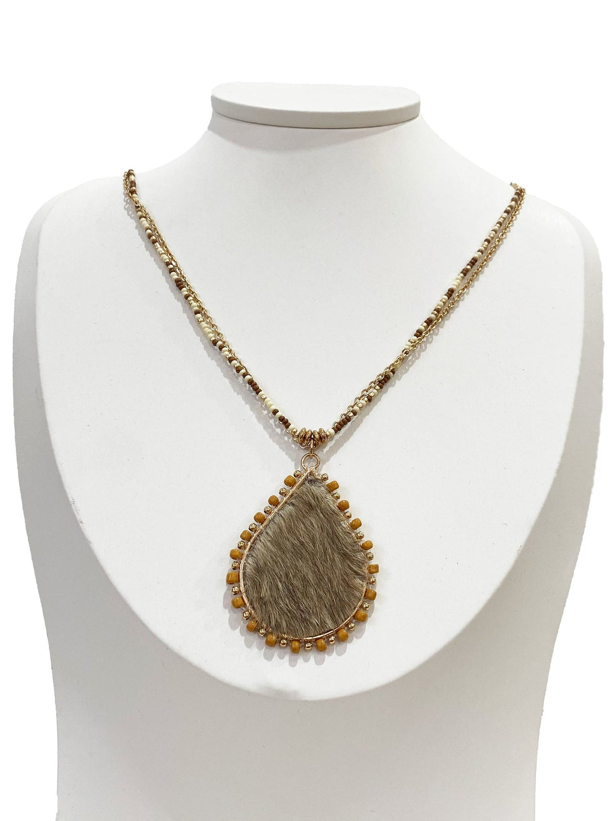 Necklace with a pendant on a white mannequin bust