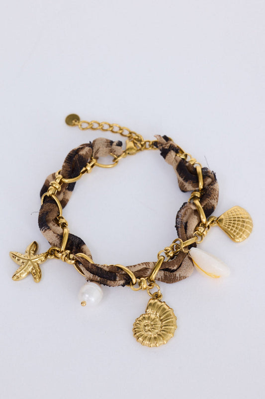Shelly Bracelet in leopard with mixed hanging charm detailing, side view on white background
