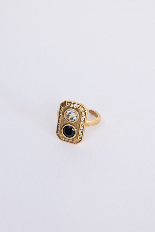 Zephyr Ring in gold with geometric face and stone detailing, front view on white background