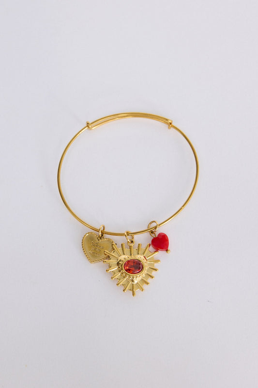 Royal Heart Bracelet in gold with multiple charm detailing, front view on white background