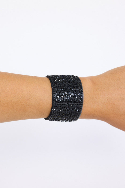 Model wearing Chantelle Bracelet in black with layered textures and embellished detailing, angled on-wrist view on neutral background