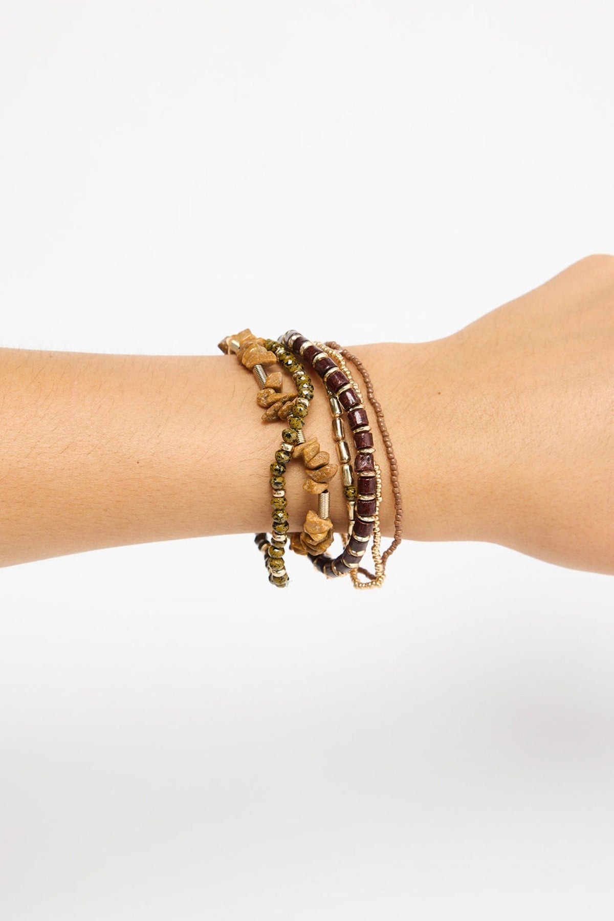 Solidarity Stack Bracelet in Natural worn stacked on the wrist, showing the multiple beaded strands layered together