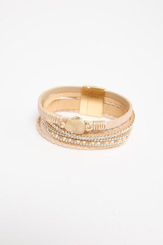 Multi-strand wrap bracelet in beige leather and crystal strands with a druzy stone charm and gold-tone magnetic clasp, shown flat on a white background
