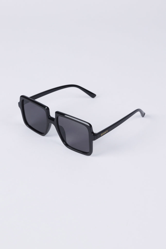 Black sunglasses on a light gray background