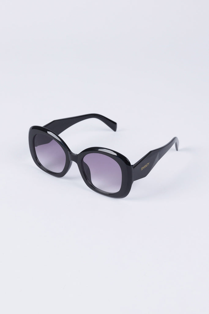 Black sunglasses with gradient lenses on a white background