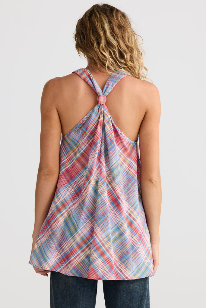 Person wearing a plaid tank top with a white background