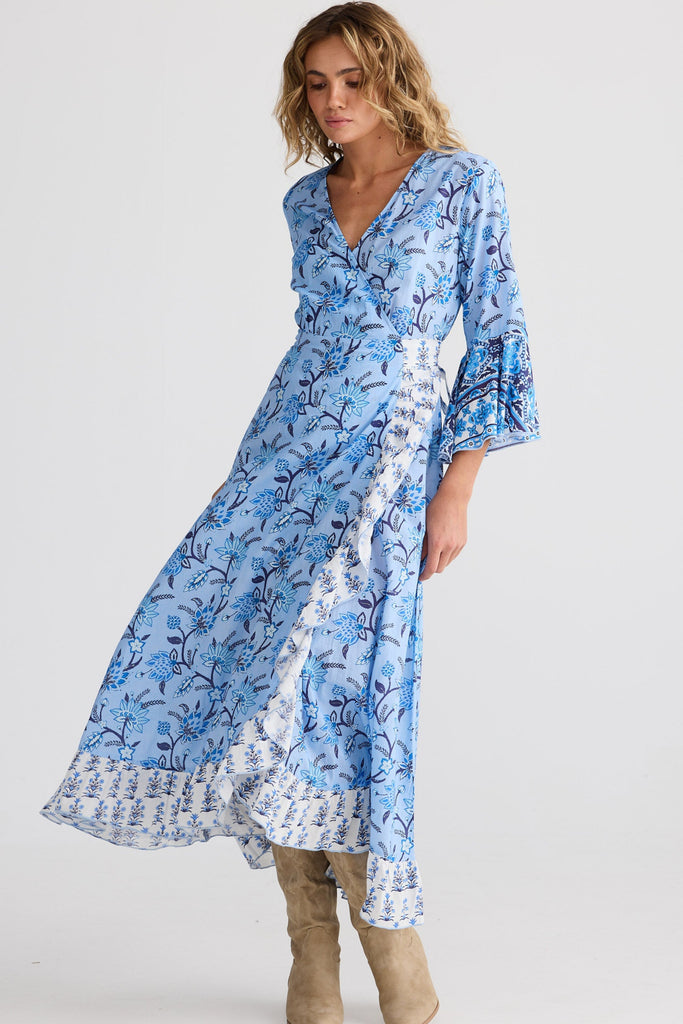 Woman wearing a blue floral dress on a white background