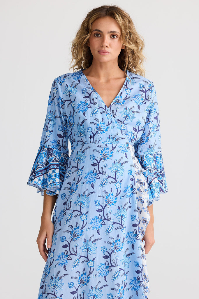Woman wearing a blue floral dress on a white background