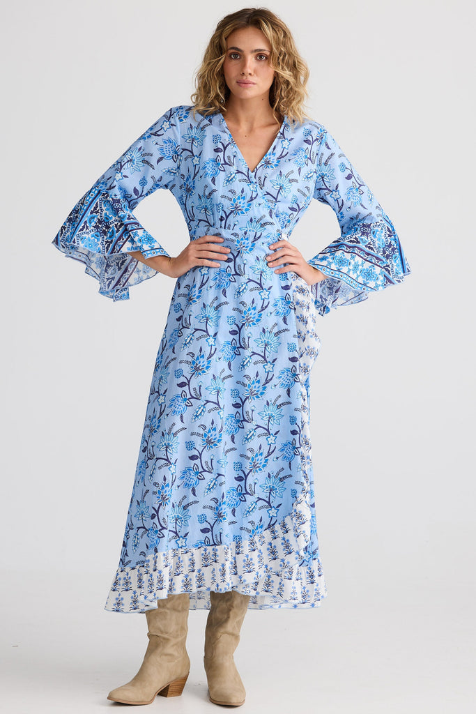 Woman wearing a blue floral dress on a white background