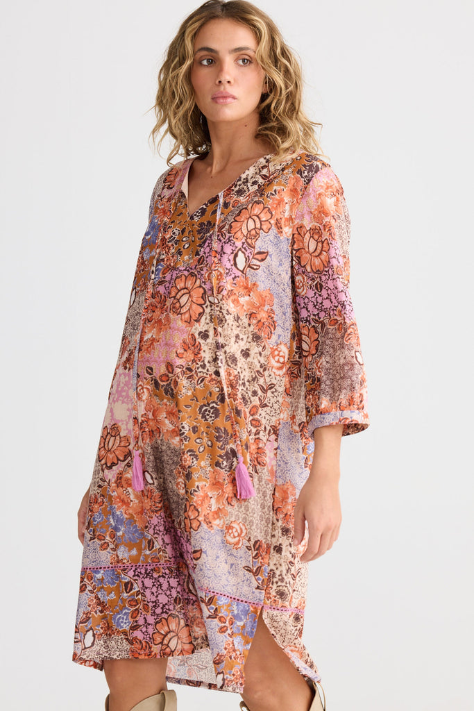 Woman wearing a floral patterned dress on a white background