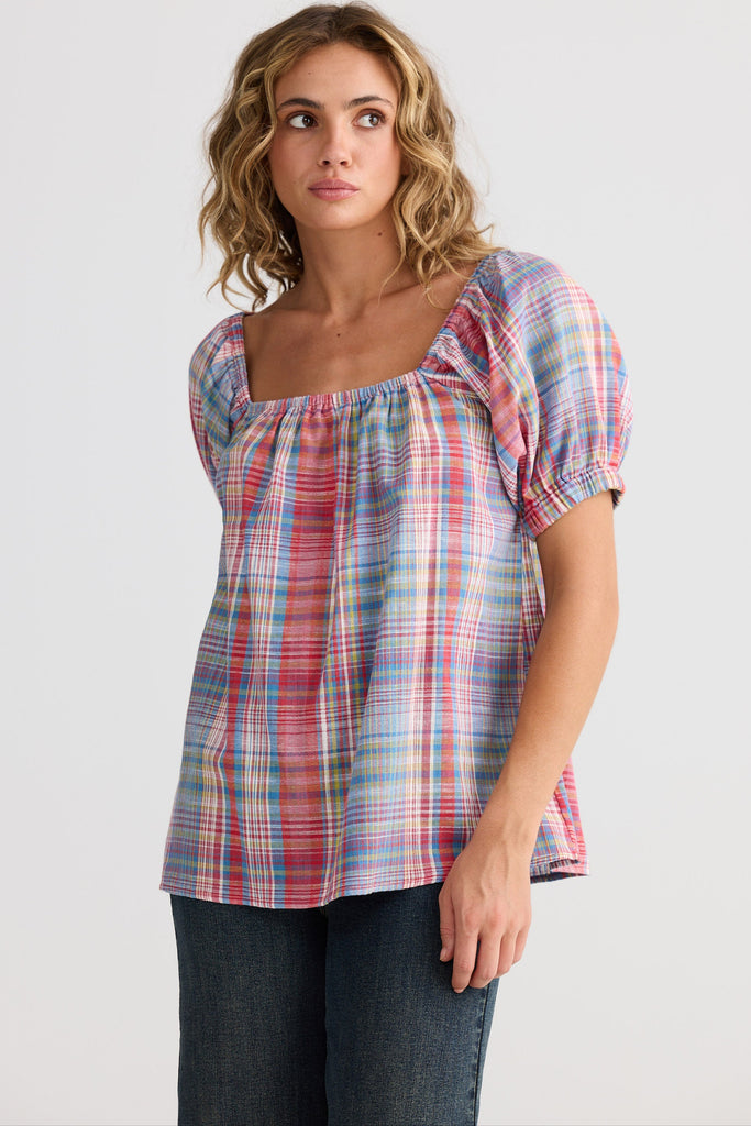 Woman wearing a plaid top on a white background