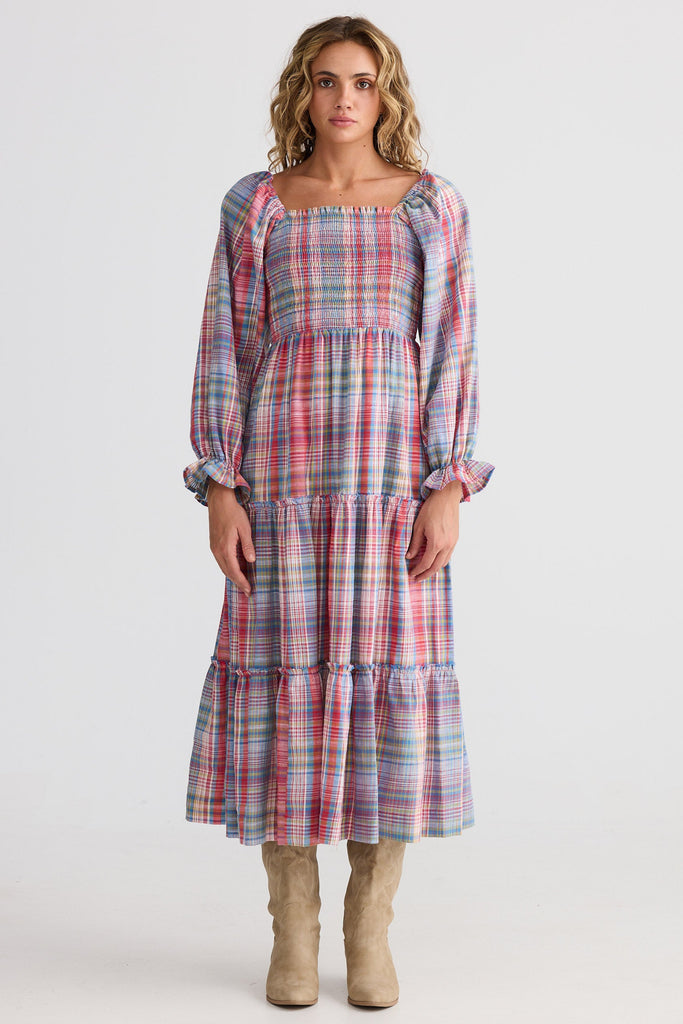 Woman wearing a plaid dress on a white background