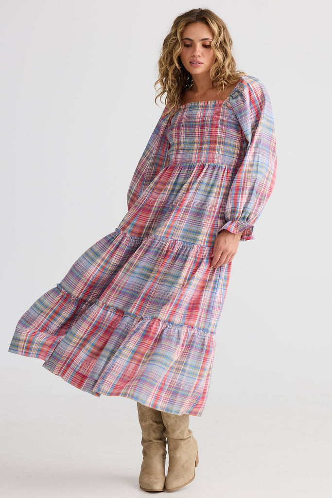 Woman wearing a plaid dress on a white background