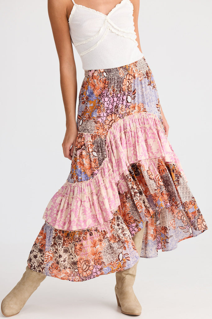 Woman wearing a colorful tiered skirt on a white background