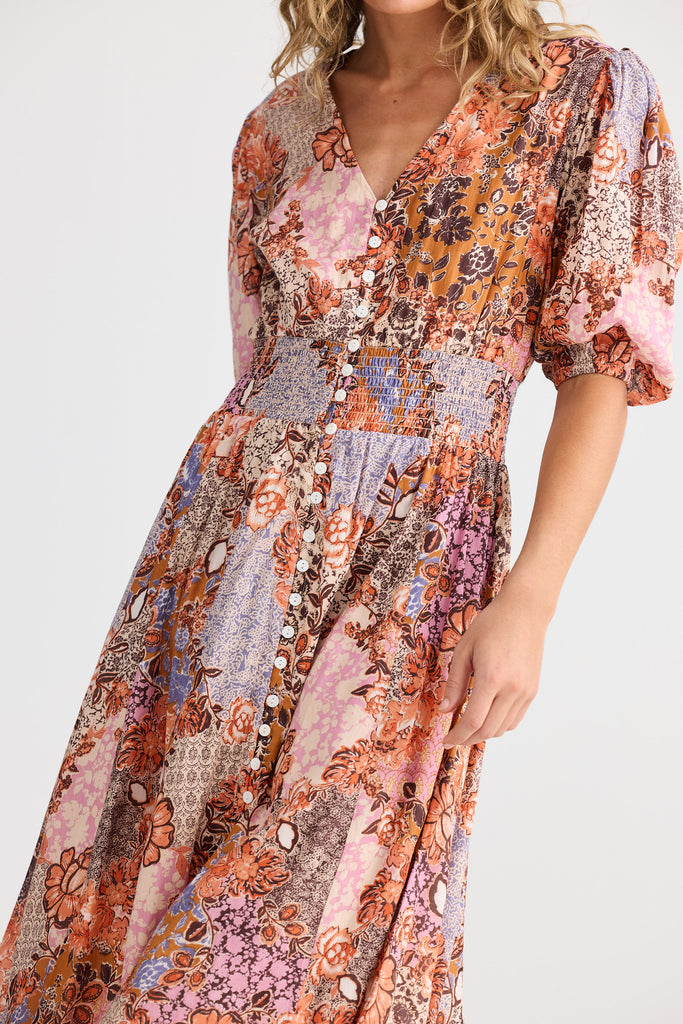 Multicolored floral dress worn by a person on a white background