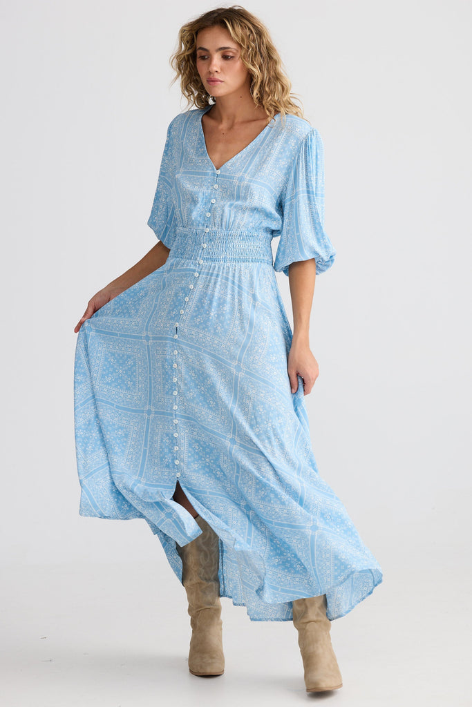 Woman wearing a light blue dress with a white background